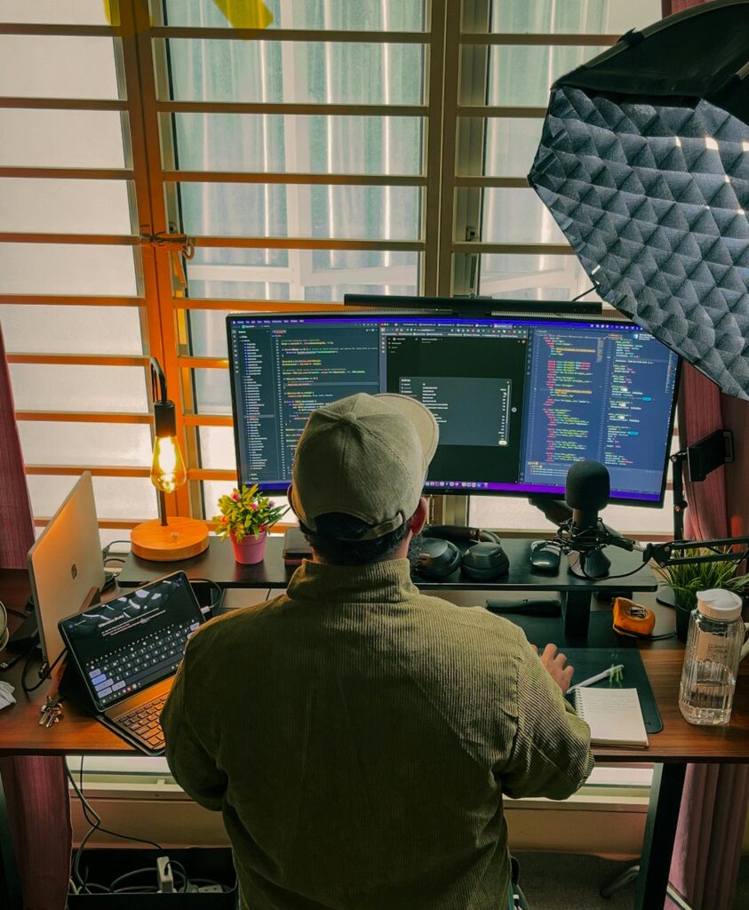 Next.js developer coding on a laptop while implementing Streaming LLM responses in Next.js with real-time Server-Sent Events.