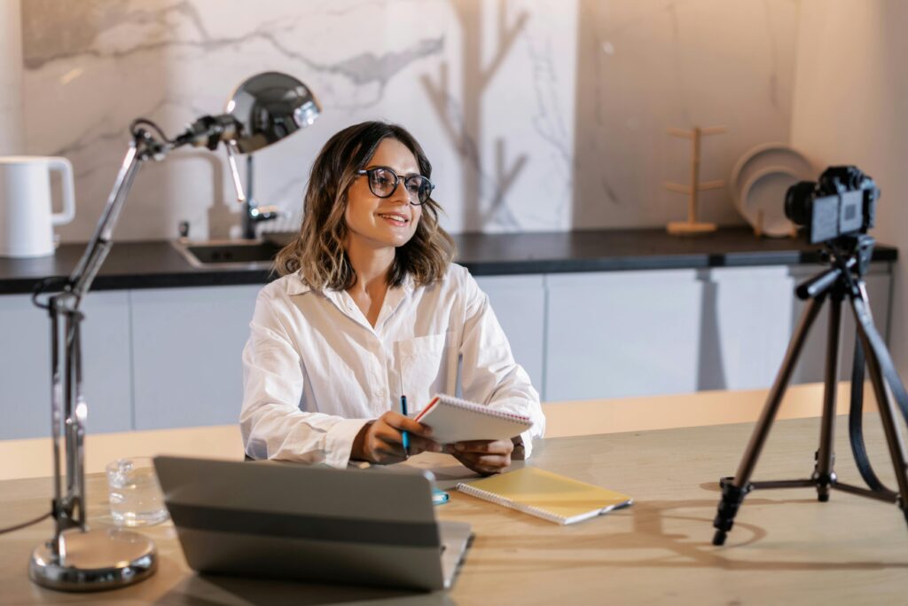 Content creator planning with laptop and mic, using the Best AI Tools for Content Repurposing to map multi-channel assets.