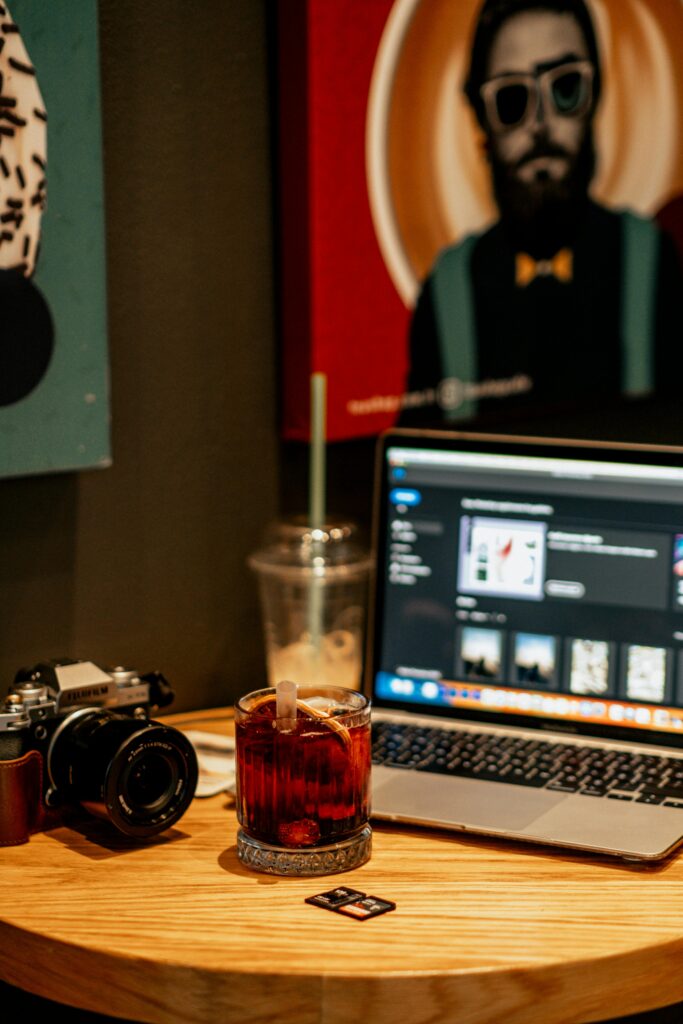 Graphic designer editing poster on laptop using the Best AI Image Generators for Creators.