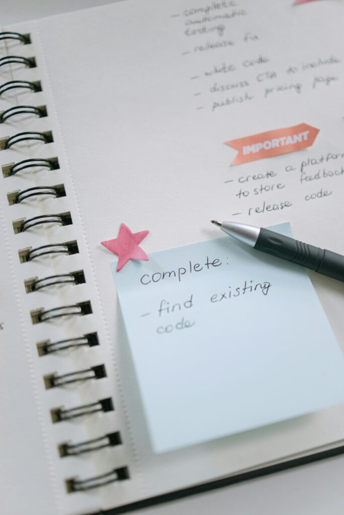 Startup planning session with sticky notes while an on-screen bot summarizes tasks—AI Assistants for Small Business streamlining workflow.