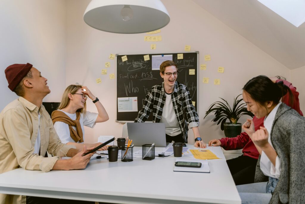 Creative marketing team brainstorming new ideas in an office using the Best AI Tools for Small Business to design and plan campaigns.